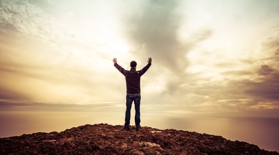 man standing under orange sky