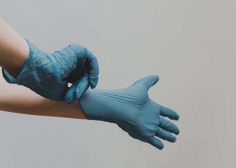 person in blue gloves and blue denim jeans