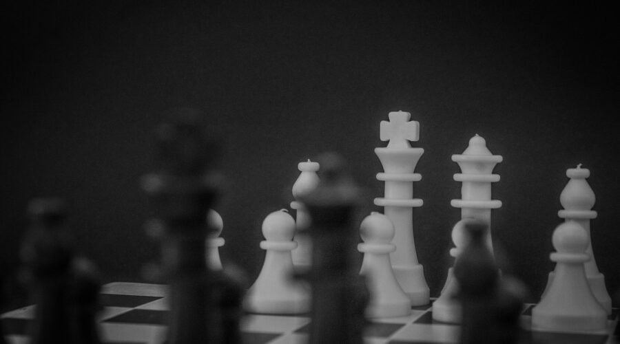 grayscale photo of a chess set