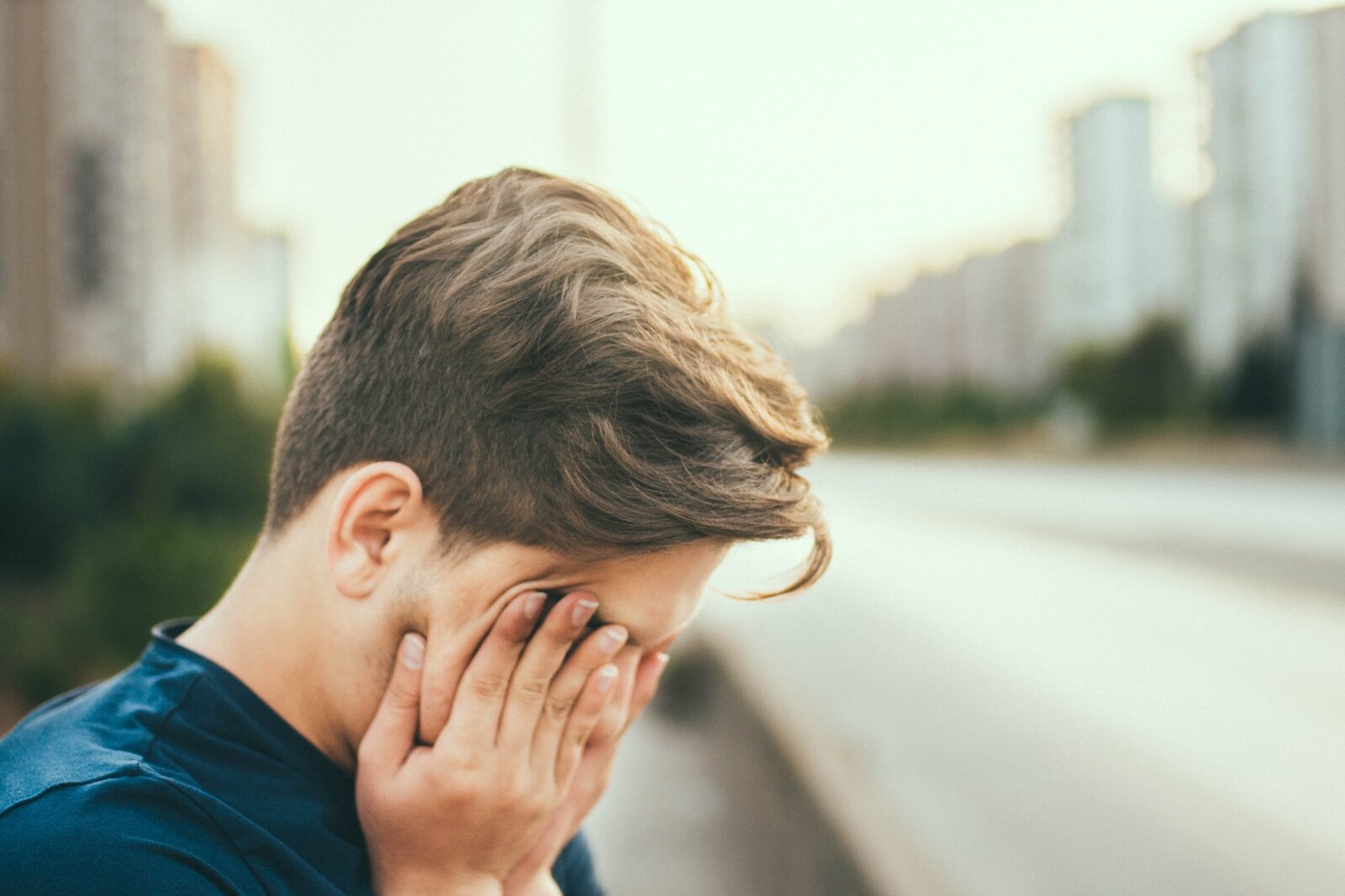 person covering own face