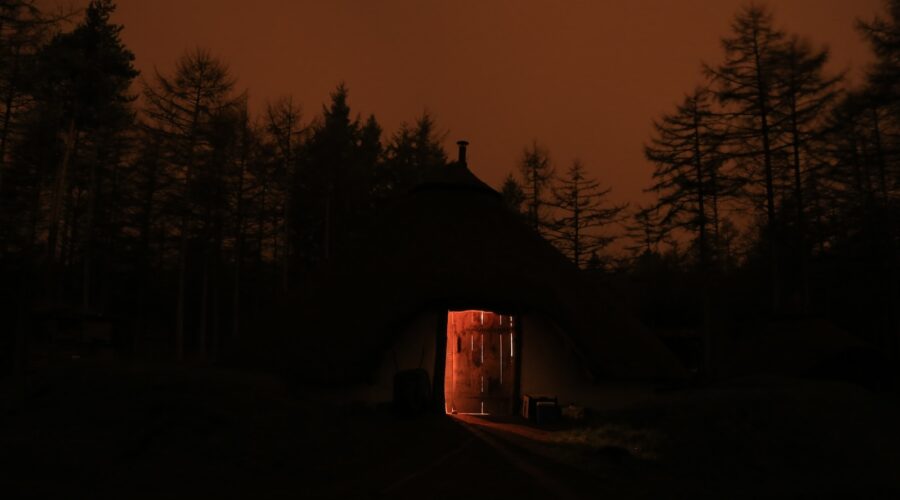 silhouette of house surrounded by trees