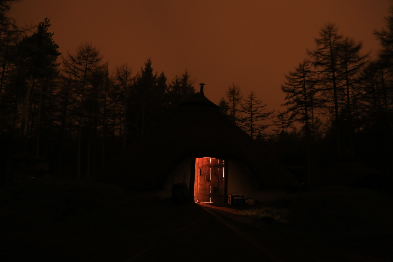 silhouette of house surrounded by trees