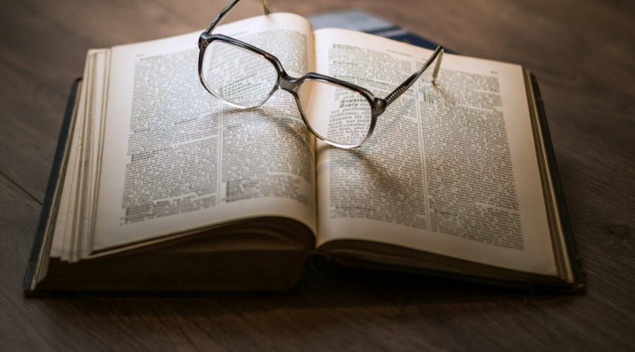 framed eyeglasses on top open book