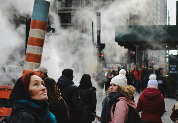 people standing near teal concrete building