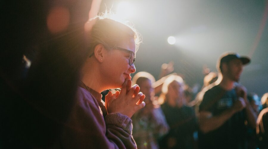 selective focus photography of woman praying