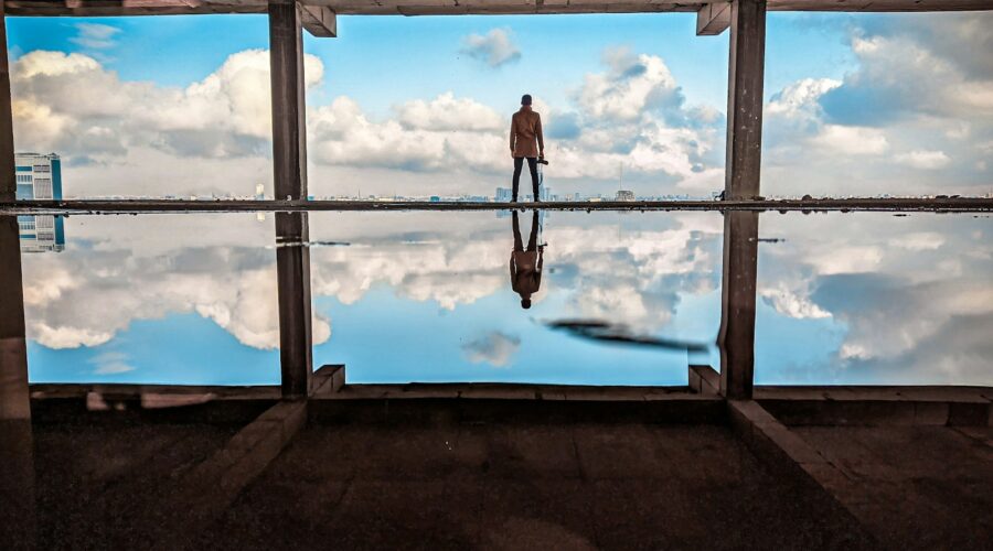 a man standing in front of a large window